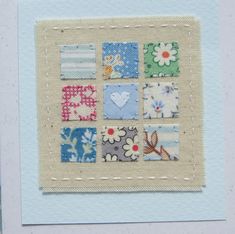 a close up of a piece of fabric with flowers and hearts on it, in a white frame