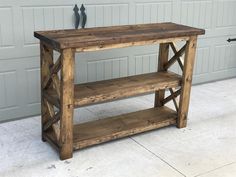 a wooden table sitting in front of a garage door