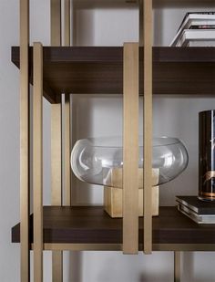 a shelf with some books and vases on it