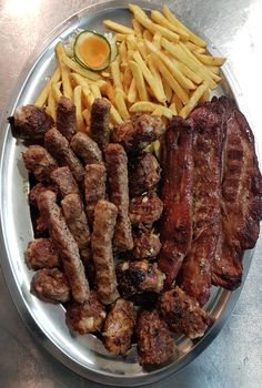 a plate full of meat and french fries