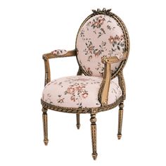 an antique chair with floral fabric and gold trimmings on the back, sitting in front of a white background