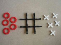 some beads and rings are laying next to each other on a table with a white background