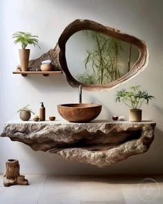 a bathroom sink made out of driftwood with plants on the shelf above it and a mirror