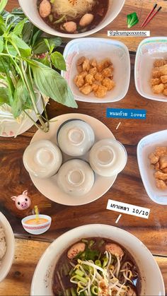 the bowls are filled with different types of food and have labels on them to describe what they are