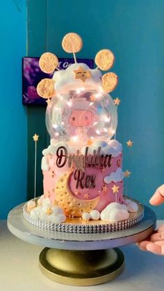 a birthday cake decorated with cookies and lights