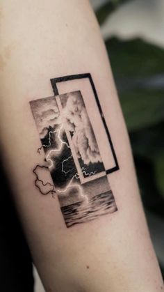 a man's arm with a black and white photo on it that has lightning coming out of the window