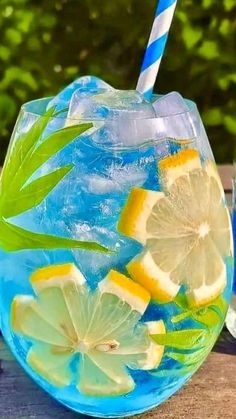 a glass filled with ice and lemon slices