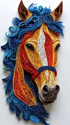 a colorful horse head made out of paper on a white surface with blue, orange and yellow swirls