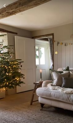 a living room with a christmas tree in the corner