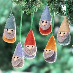 christmas ornaments hanging from a tree in the shape of gnomes