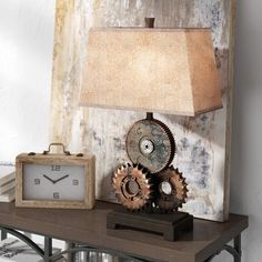 a table with a lamp and clock on it