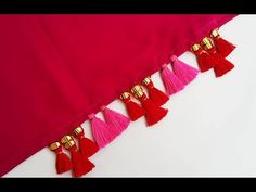 the tassels are hanging from the red fabric