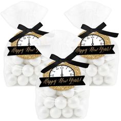 two bags filled with white and gold candies, one has a clock on it