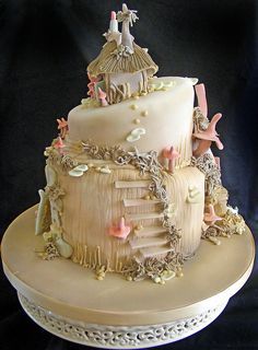 a three tiered cake with an angel on top