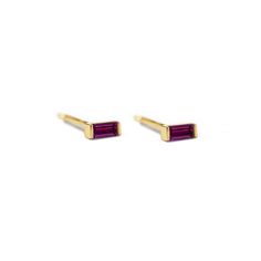 pair of gold and amethyste earrings with purple stones on the sides, set against a white background