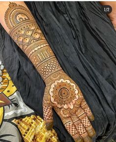 a woman's hand with henna tattoos on it