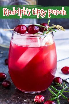 a glass filled with cranberry punch on top of a table