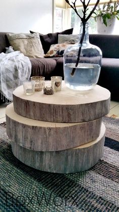 a table made out of wood with a vase and water in it sitting on top of a rug