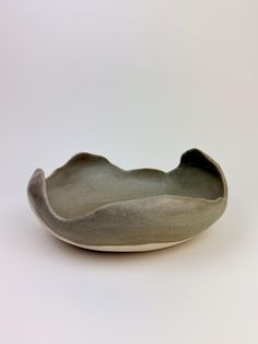 a gray bowl sitting on top of a white table