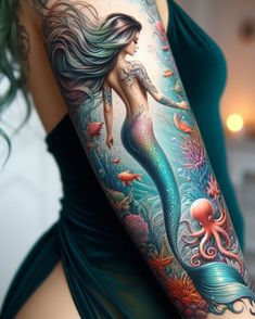 a woman's arm with an octopus and mermaid tattoo design on the left side of her body