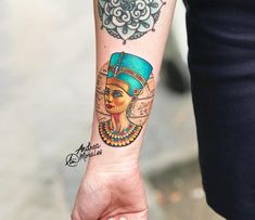 an egyptian woman's arm with a tattoo on her left wrist and the head of a pharaoh