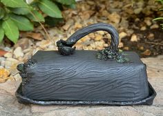 a black purse sitting on top of a rock