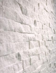 a white brick wall with snow on it