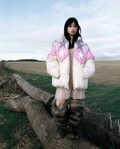 a woman standing on top of a fallen tree