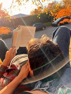 a person laying on the ground reading a book