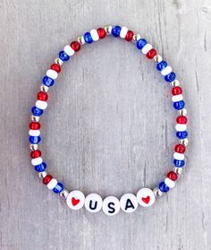 a bracelet with the word usa written in red, white and blue beads on it