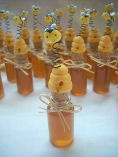 a bottle filled with honey sitting on top of a table next to other bottles full of honey