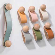 an assortment of different colored wooden objects on a white surface