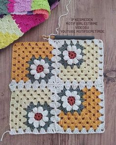 a crocheted square with flowers on it