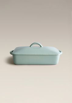 a blue casserole dish sitting on top of a table