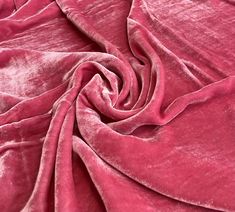 a close up view of a pink velvet fabric