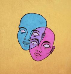 two blue and pink faces on a yellow shirt