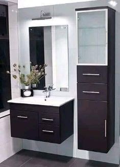 a bathroom with a sink, mirror and cabinets in black and white colors on the walls