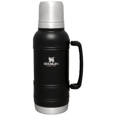 the stanley stainless steel insulated mug is black and silver with a white cap on it