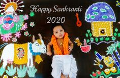 a baby sitting on top of a chalk board covered in crayons and decorations