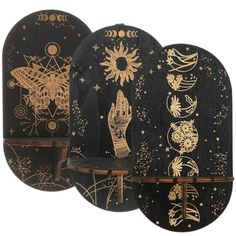 three black and gold plates with designs on them