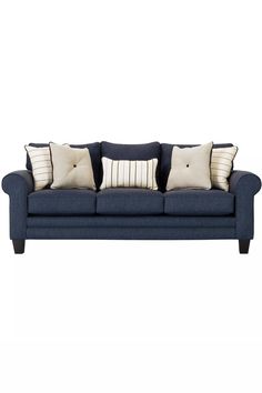 a blue couch with four pillows on it