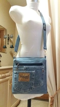 a white mannequin wearing a blue jean purse