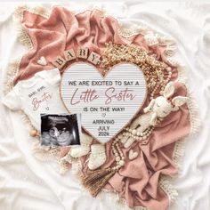 a baby announcement with a heart shaped photo and an infant's handwritten message