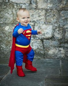 a baby dressed up as superman standing in front of a stone wall with the caption top 25 best toddler superhero costume ideas