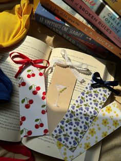 an open book sitting on top of a table next to other books and paper decorations