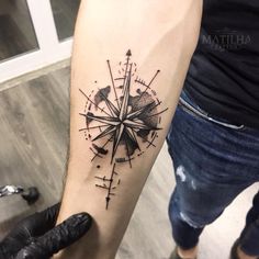 a person with a compass tattoo on their arm