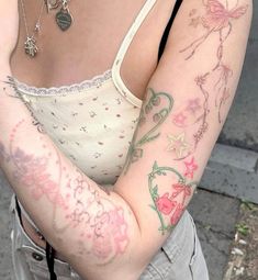 a woman with tattoos on her arm and shoulder