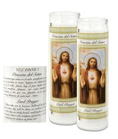 two candles with the image of jesus on them