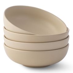 four white bowls stacked on top of each other