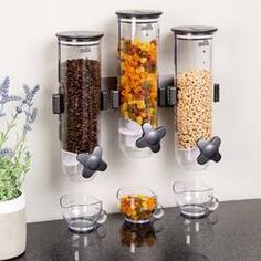 three glass containers filled with food on top of a counter